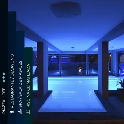 a swimming pool in a house at night at Piazza Hotel in Villa Carlos Paz