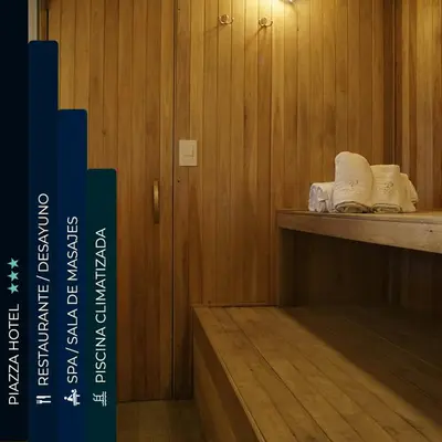 a room with wooden walls and a shelf with towels at Piazza Hotel in Villa Carlos Paz