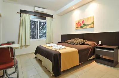 a bedroom with two beds and a window at Casa Nostra Hotel in Villa Carlos Paz