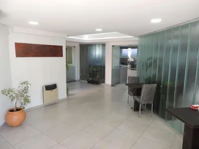 an office lobby with a table and chairs at Casa Nostra Hotel in Villa Carlos Paz