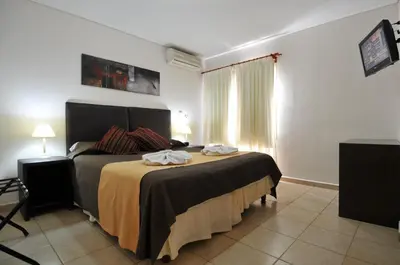 a bedroom with a large bed in a room at Casa Nostra Hotel in Villa Carlos Paz