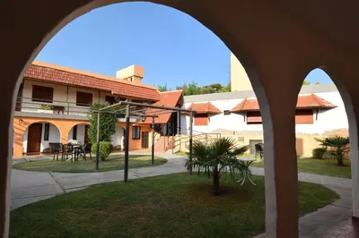 a view of a courtyard from an archway at Hotel Marengo in Mina Clavero