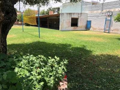 a building with a basketball hoop in a park at Hotel Marengo in Mina Clavero