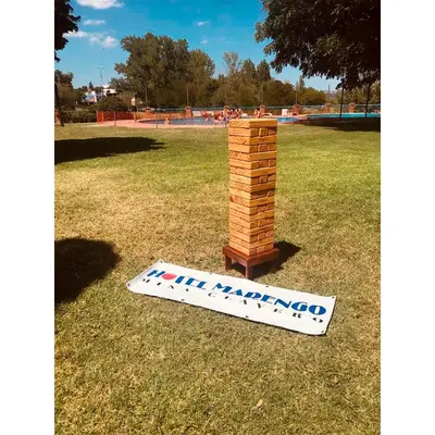a wooden tower on the grass in a park at Hotel Marengo in Mina Clavero