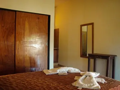 a bedroom with a bed with towels on it at Hotel Marengo in Mina Clavero