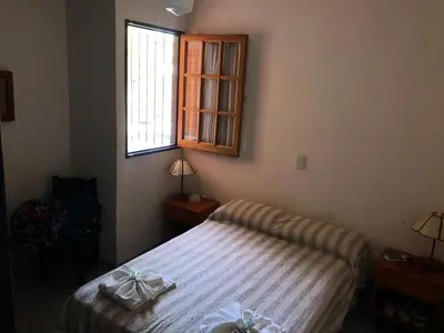 a small bedroom with a bed and a window at Hotel Marengo in Mina Clavero
