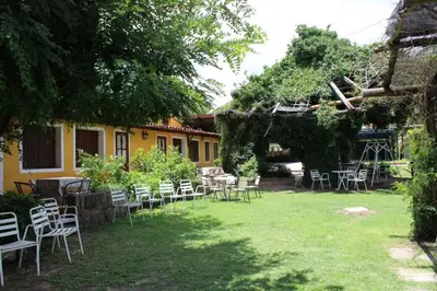 a group of chairs and tables in a yard at Tico Tico Apart in Mina Clavero