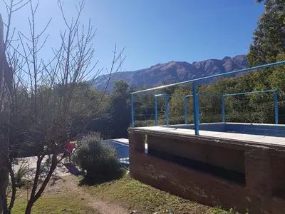 a tennis court on a building with mountains in the background at Cabañas Wayramuyu in Merlo