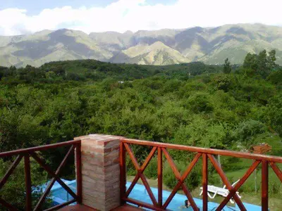 a wooden bridge with a view of a mountain at Cabañas Wayramuyu in Merlo