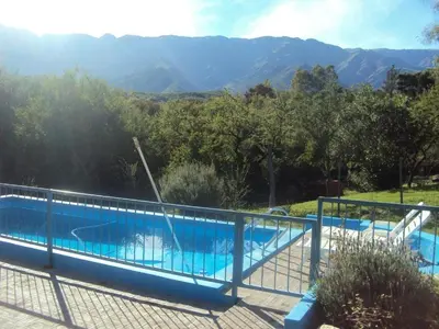 a swimming pool with a view of the mountains at Cabañas Wayramuyu in Merlo