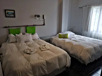 two beds sitting next to each other in a bedroom at Noria Hotel in Villa Carlos Paz