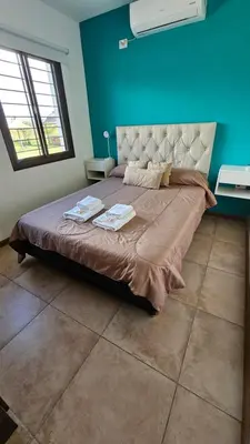 a bedroom with a large bed with blue walls at La Guarida del Zorro in Merlo