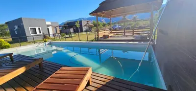 a swimming pool with a gazebo on a house at La Guarida del Zorro in Merlo