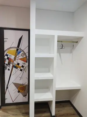a room with white shelves and a stained glass window at La Guarida del Zorro in Merlo