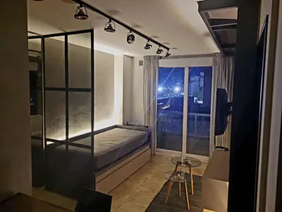 a small room with a bed and a window at night at DOMUS APART in Río Cuarto