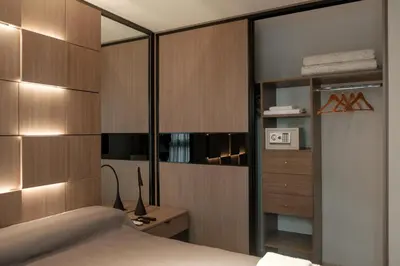 a bedroom with wooden walls and a bed and a desk at DOMUS APART in Río Cuarto