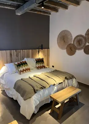 a bedroom with a large bed and a table at Estancia Acuarela del Río in San Clemente