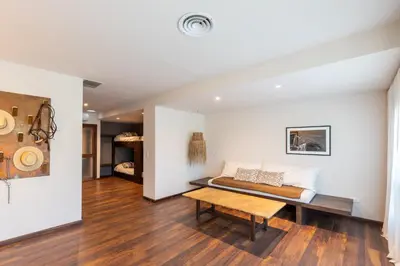a living room with a bed and a table at Estancia Acuarela del Río in San Clemente