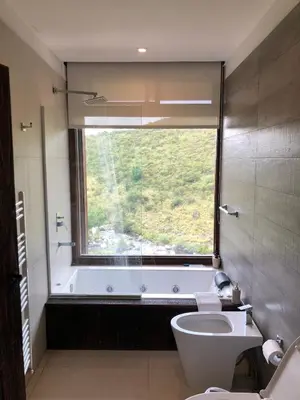 a bathroom with a tub and a toilet and a window at Estancia Acuarela del Río in San Clemente