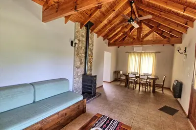 a living room with a couch and a fireplace at Casas de Campo Henin in Villa General Belgrano