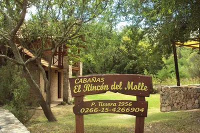 a sign in front of a house in a yard at El Rincón del Molle in Merlo