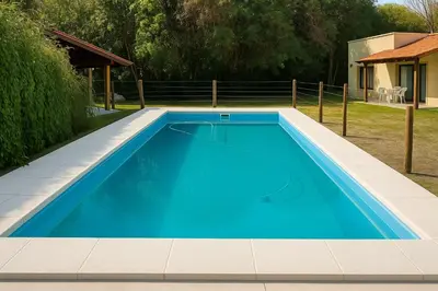 a blue swimming pool in a yard at El Rincón del Molle in Merlo