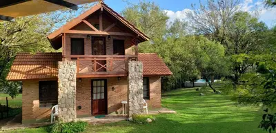 a small house in the middle of a yard at El Rincón del Molle in Merlo