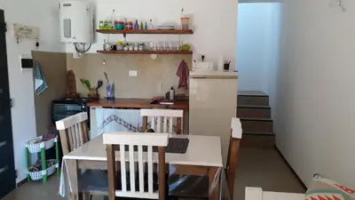 a kitchen with a table and chairs in a room at Ensueño in Santa Rosa de Calamuchita
