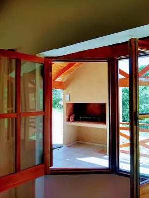 a room with a glass door and a fireplace at CAMINITOS in Villa General Belgrano