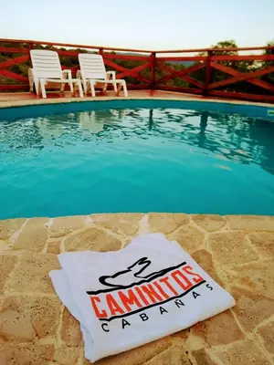a sign sitting on the side of a swimming pool at CAMINITOS in Villa General Belgrano