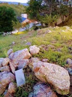 a pile of rocks in a field of grass at CAMINITOS in Villa General Belgrano