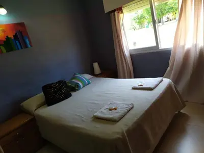 a bedroom with a bed with two towels on it at Casa de campo La Querencia in Villa Cura Brochero