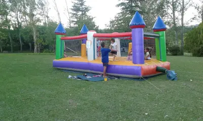 a boy is playing in a play structure in a park at Casa de campo La Querencia in Villa Cura Brochero