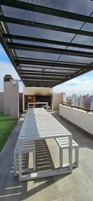 a white table on the roof of a building at LitStay Brasil con cochera, pileta y asadores in Cordoba