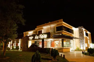 a building with a sign on it at night at La Frida Hotel - ADULTS ONLY in Nono