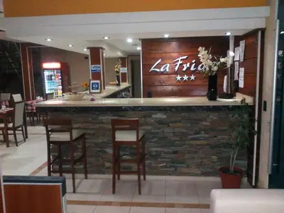 a restaurant with a bar with wooden stools at La Frida Hotel - ADULTS ONLY in Nono