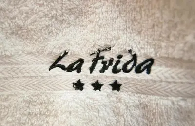 a white towel with the word latino written on it at La Frida Hotel - ADULTS ONLY in Nono