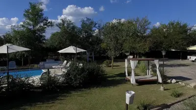 a backyard with a pool with a swing and umbrellas at La Frida Hotel - ADULTS ONLY in Nono