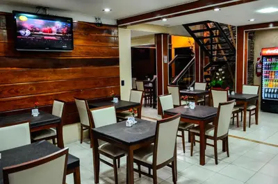 a restaurant with tables and chairs and a tv on a wall at La Frida Hotel - ADULTS ONLY in Nono