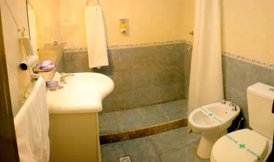a bathroom with a shower and a sink and a toilet at Complejo Sol in Villa Carlos Paz