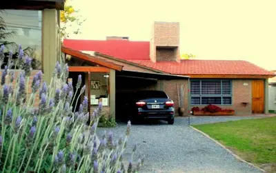 a car parked in the driveway of a house at Complejo Sol in Villa Carlos Paz
