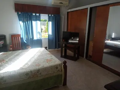 a bedroom with a bed and a desk and a television at Casa a 5 km de Villa de Las Rosas in Las Tapias