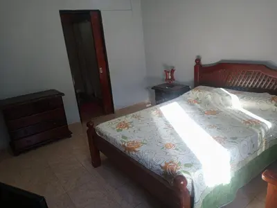 a bedroom with a bed with a wooden frame and a dresser at Casa a 5 km de Villa de Las Rosas in Las Tapias