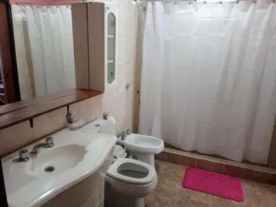 a bathroom with a white toilet and a sink at Casa a 5 km de Villa de Las Rosas in Las Tapias