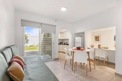 a kitchen and living room with a table and chairs at El Puerto - Cerca de todo in Cordoba