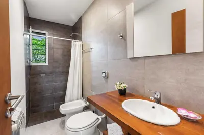 a bathroom with a sink and a toilet and a shower at El Puerto - Cerca de todo in Cordoba