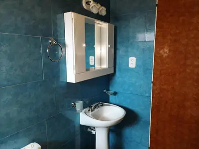 a bathroom with a sink and a mirror at Ruta 20 HOUSE Quines in Quines