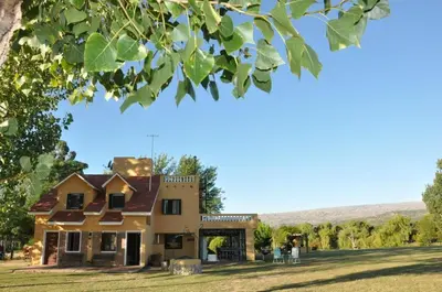 a house with people standing in front of it at Casa grande La Querencia in Villa Cura Brochero