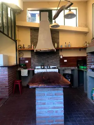a kitchen with a sink and a stove top oven at Casa grande La Querencia in Villa Cura Brochero