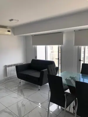 a living room with a couch and a glass table at FOREST 7º in Cordoba